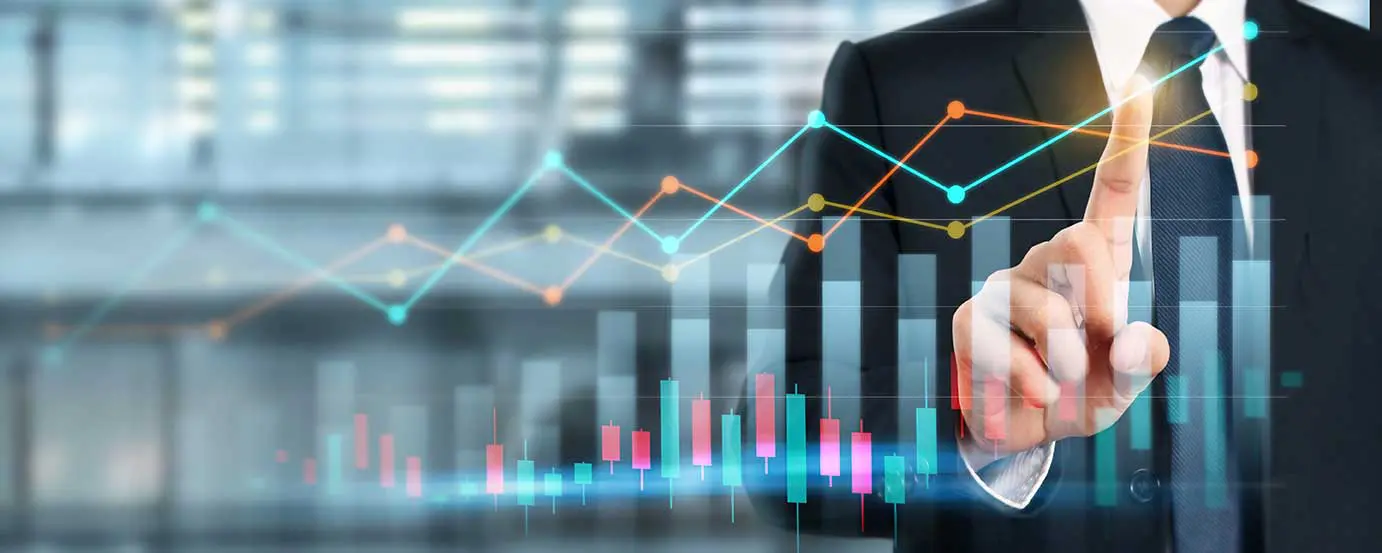 Businessman points at virtual financial charts, displaying stock market data and growth trends