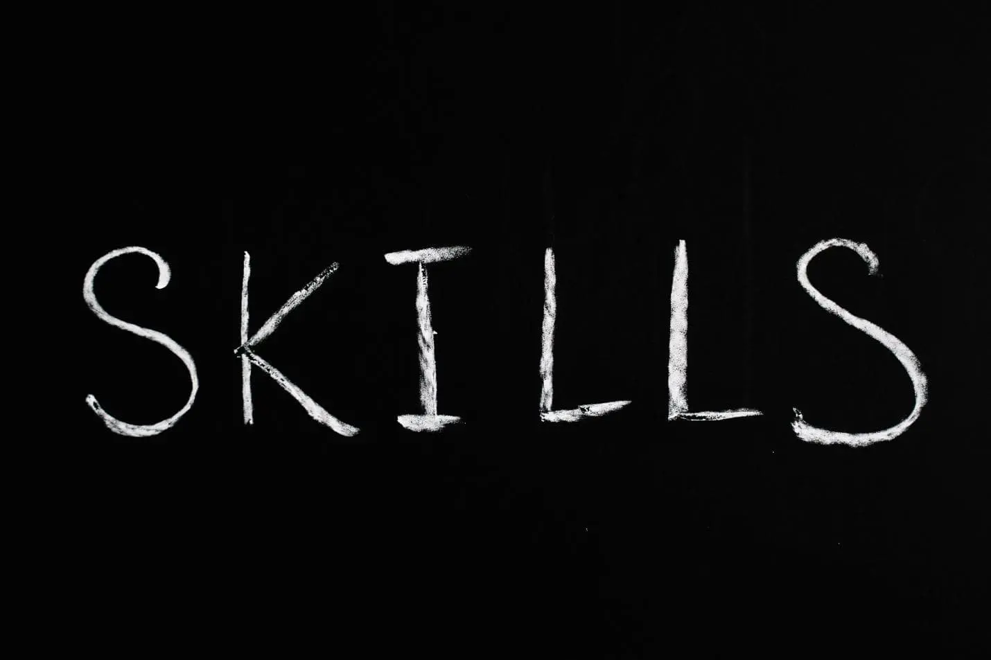 The word SKILLS written in white chalk on a black school chalkboard