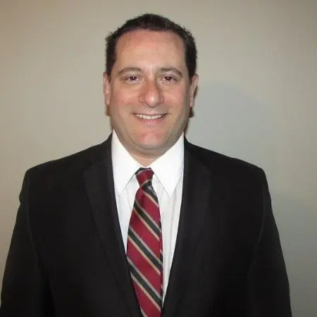 Smiling professional businessman headshot in black suit and striped tie