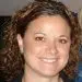 Smiling woman with curly brown hair, professional headshot