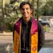 Smiling first-generation student with maroon and gold graduation stole