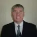 Professional man in black business suit, white shirt, patterned tie