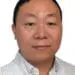 Professional headshot of an East Asian man wearing a light plaid shirt